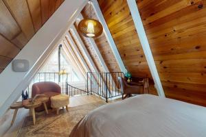 a bedroom with a bed and a staircase with wooden ceilings at Elati Escape in South Lake Tahoe