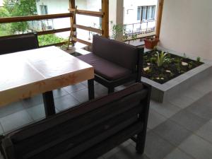 a balcony with two chairs and a table and a plant at Apartment Dimitrieski in Višegrad