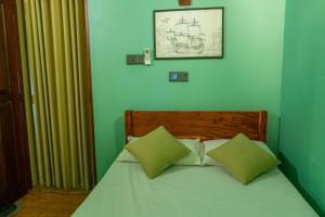 a bedroom with a bed with green walls at Rose Villa by Kananke Hills in Kananke +37 photos