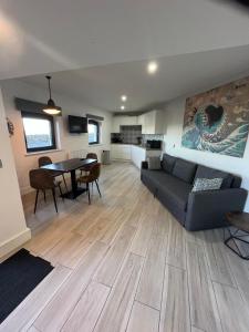 a living room with a couch and a table at The Anchor in Skerries