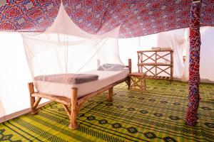 a bedroom with a bed in a tent at Eden Lodge - Desert Camp in Kébémèr