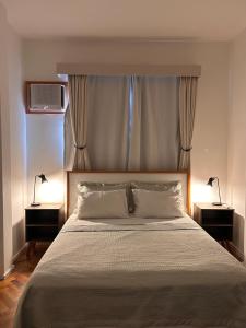 a bedroom with a large bed with two night stands at Apê 5 min da praia de Copacabana, Pet Friendly in Rio de Janeiro