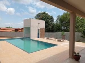 a swimming pool in the middle of a house at Sitio Vila Monte Verde in Jaboticatubas