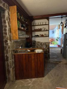 a kitchen with a counter and a stone wall at къща Солунови in Dobrinishte +8 photos