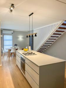 a kitchen with a stove and a staircase at 12 Langdown Ridge in Plettenberg Bay