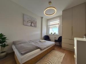 a bedroom with a bed in a room with a window at Apartamenty Zajazd u Marcela in Tuchola