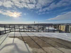 a view from the roof of a building with snow on the ground at Apartamenty Zajazd u Marcela in Tuchola