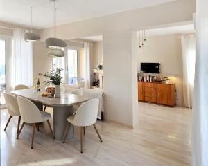 a dining room and living room with a table and chairs at Silver Moon Villa in Achlia