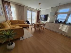 a living room with a couch and a table at Apartamenty Zajazd u Marcela in Tuchola