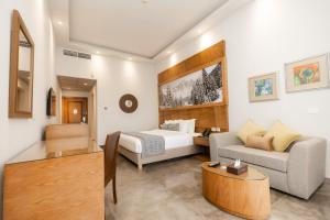 a hotel room with a bed and a couch at Cancun Sokhna Resort & Villas in Ain Sokhna +201 photos