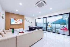 a living room with a couch and a pool table at Panmora Poolvilla Sattahip in Ban Tao Than