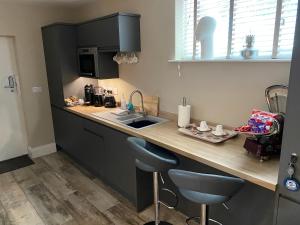 a kitchen with a counter top with a sink and a counter top at The View, Luxury studio in Curbar