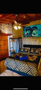 a bedroom with a bed and a ceiling fan at Minas Em Marambaia in Rio de Janeiro