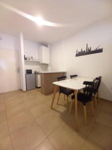 a kitchen and dining room with a table and chairs at Osiris Plaza in Buenos Aires +8 photos