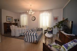 a living room with a tv and a table and chairs at Villa Radovani Jelsa Hvar in Jelsa