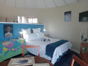a bedroom with a large bed with a blue headboard at Riverview Loft Suite Bonza Bay in East London