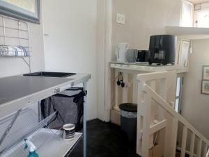 a kitchen with a sink and a microwave on a shelf at Riverview Loft Suite Bonza Bay in East London +39 photos