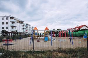 a playground with colorful swings in a city at Apartament Panorama Boho in Mława