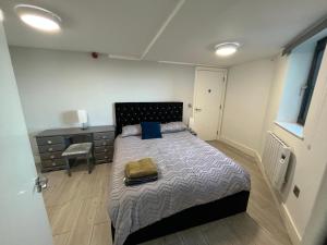 a bedroom with a bed and a dresser and a desk at The Captains Wheel and Anchor in Skerries