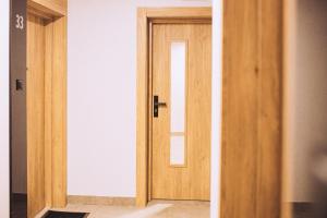 an open wooden door in a room at Apartament Panorama Boho in Mława