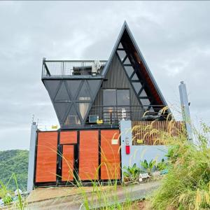 a house with a triangular roof on top of it at Tasha's Place in Antipolo