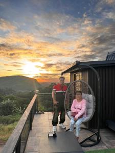a man and a woman sitting in a chair on a balcony at Tasha's Place in Antipolo +3 photos