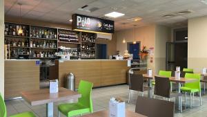 a restaurant with tables and chairs and a bar at The Polo Hub in Mortara