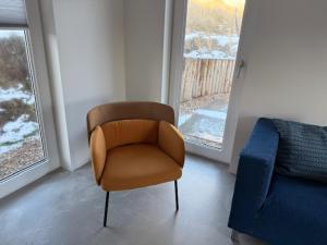 a living room with a chair and a couch at Studio 14 in Nes