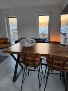 a dining room with a wooden table and chairs at Studio 14 in Nes