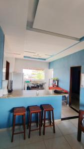 a kitchen with two stools and a counter in a room at Hostel Casa da Cida II in Pipa +34 photos