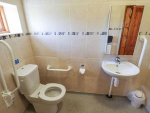 a bathroom with a toilet and a sink at The Stables in Louth +16 photos