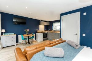 a living room with a couch and a kitchen at Annabelle's Den in Gatehouse of Fleet +36 photos