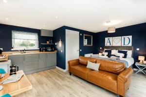 a living room with a couch and a bed at Annabelle's Den in Gatehouse of Fleet