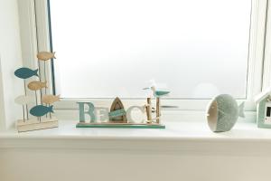 a window sill with a shelf with figurines on it at Annabelle's Den in Gatehouse of Fleet
