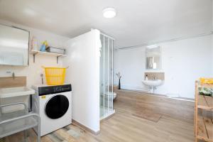 a bathroom with a washing machine and a sink at Mima House with Pool in Canyelles