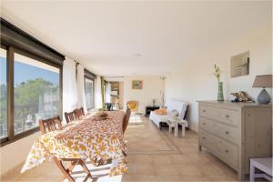 a dining room with a table and chairs in a room at Mima House with Pool in Canyelles +22 photos