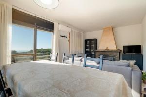 a bedroom with a large bed and a couch at Mima House with Pool in Canyelles