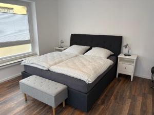 a bed in a room with two tables and a window at Centrally located in Coesfeld in Coesfeld