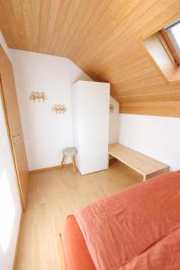 a bedroom with a bed and a wooden ceiling at Quiet Forest-Side Apartment in Flamatt