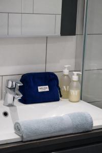 a bathroom sink with a blue bag on it at Résidence A Stella in Piana +39 photos