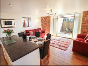 a kitchen and living room with a table and chairs at The Granary in Louth