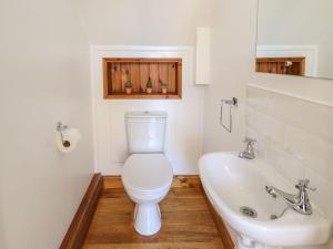 a bathroom with a toilet and a sink at The Granary in Louth +18 photos