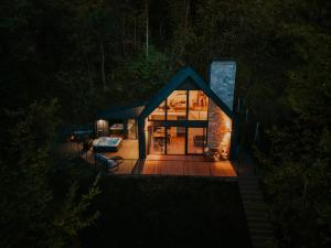 a small house in the woods at night at Lake Forest Kabin in Bárdudvarnok
