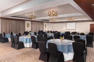 a banquet hall with tables and chairs and a screen at Radisson Resort Goa Baga in Baga +46 photos