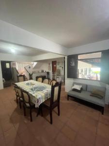 a living room with a table and a couch at Casa Vila lagoinha in Lagoinha +28 photos