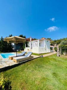 a villa with a swimming pool and a house at Nafsika Residences ex Petra Mare Village in Kerveli