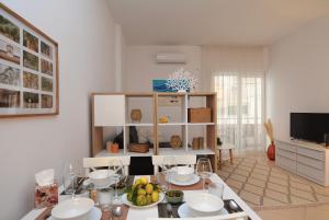 a living room with a table with food on it at All Seasons Apartment in Durrës