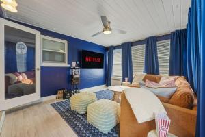 a living room with a couch and blue walls at Resort Style Backyard Pool Hot Tub Games in Seminole +56 photos