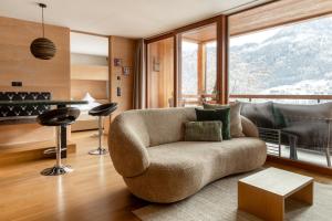 a living room with a couch and a table at Gran Tubla Apartments Dolomites in Ortisei
