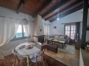 a living room with a table and a couch at Ektor Villa in Agios Georgios
